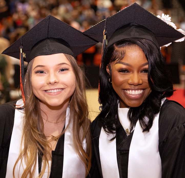Two Commencement students smiling